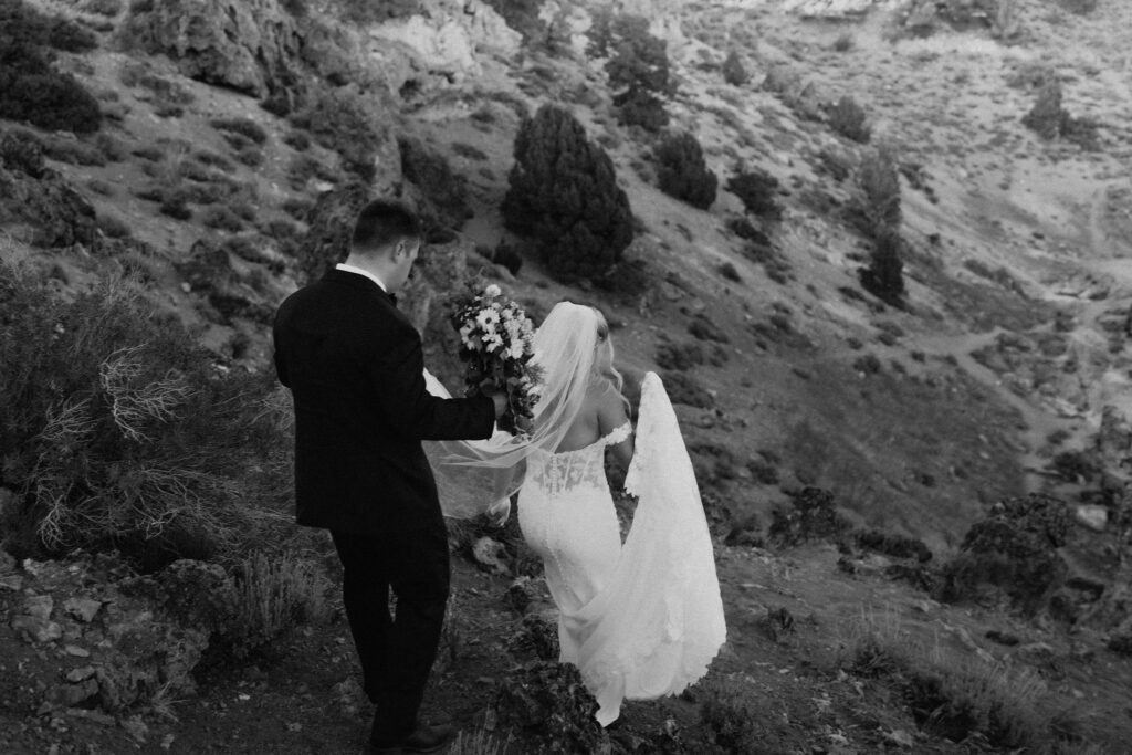 bride and groom going on a hike together during their adventure elopement