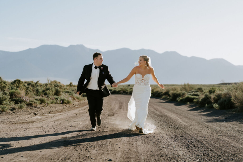 newlyweds running on a secluded country road 