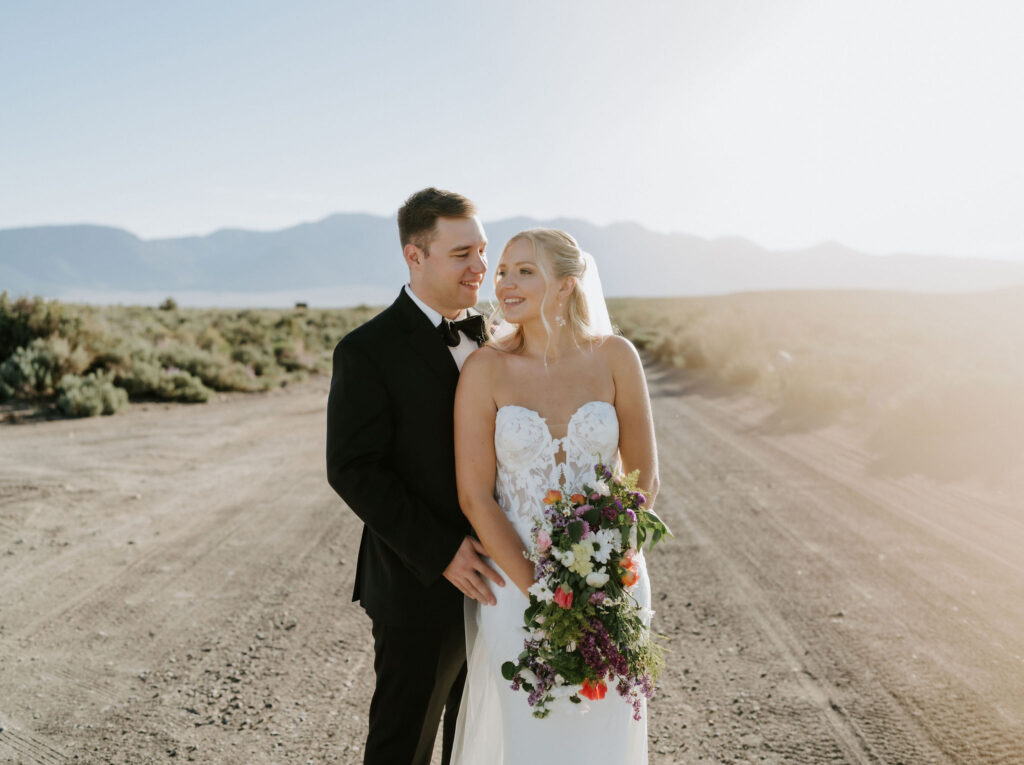 newlyweds posing on a secluded country road 