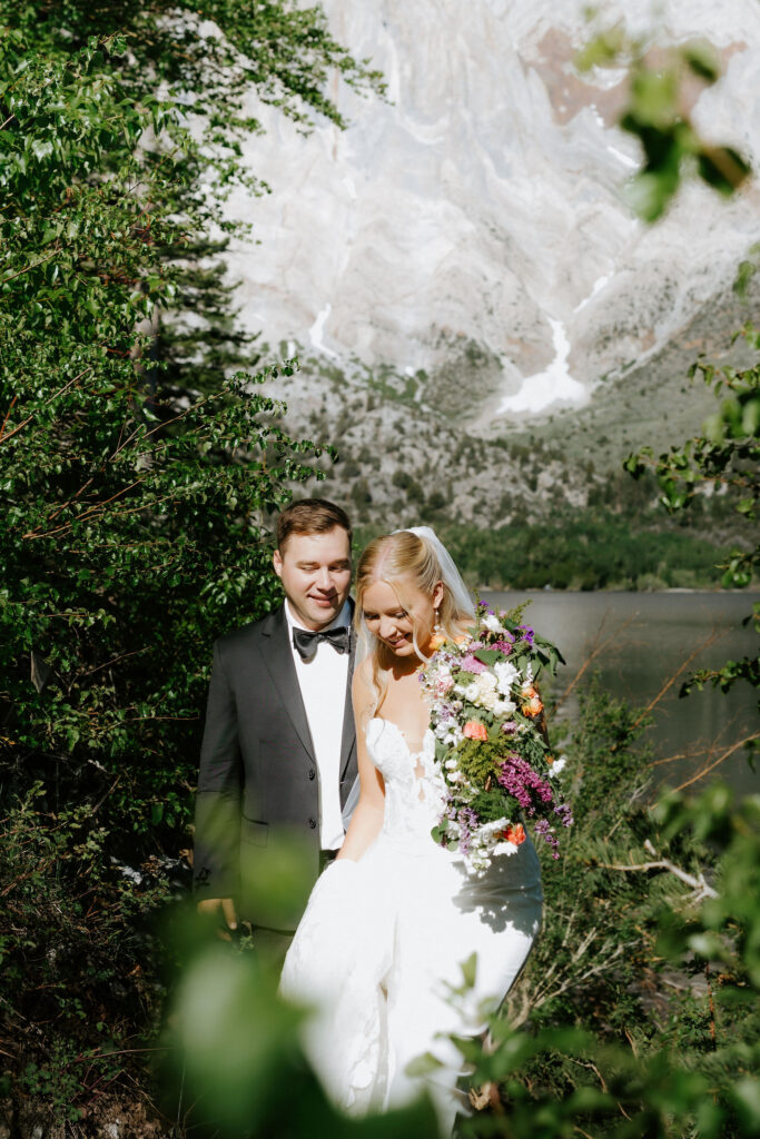 bride and groom surrounded by lush greenery