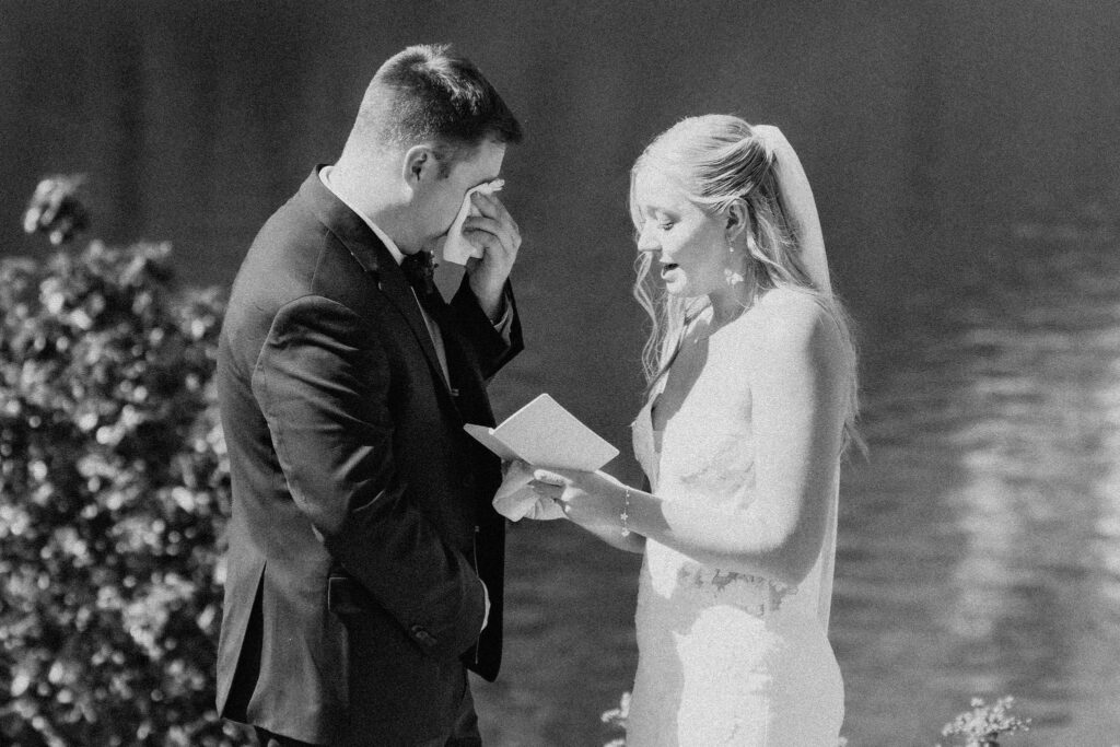 bride and groom exchanging private vows next to a gorgeous lake