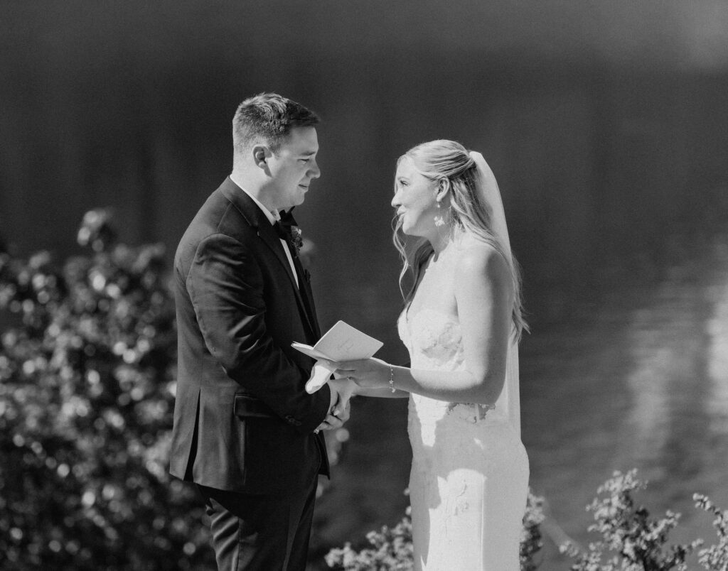bride and groom exchanging private vows next to a gorgeous lake