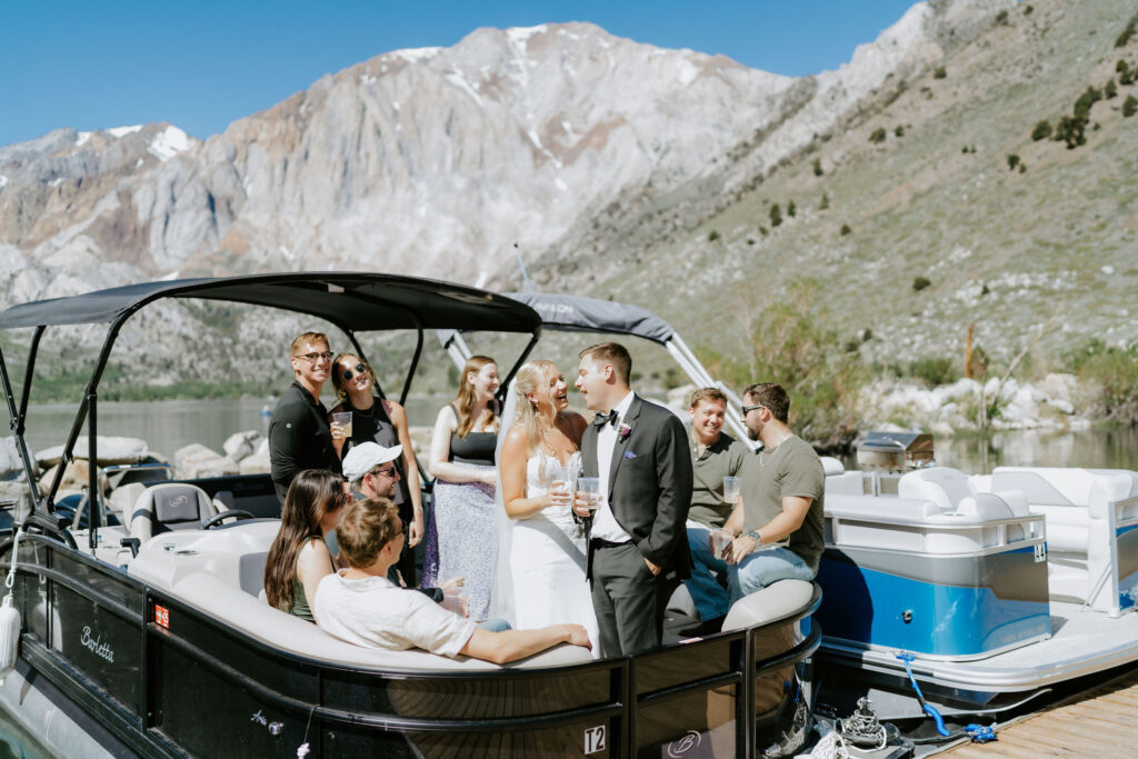 bride and groom and guests in a pontoon boat in mammoth lakes