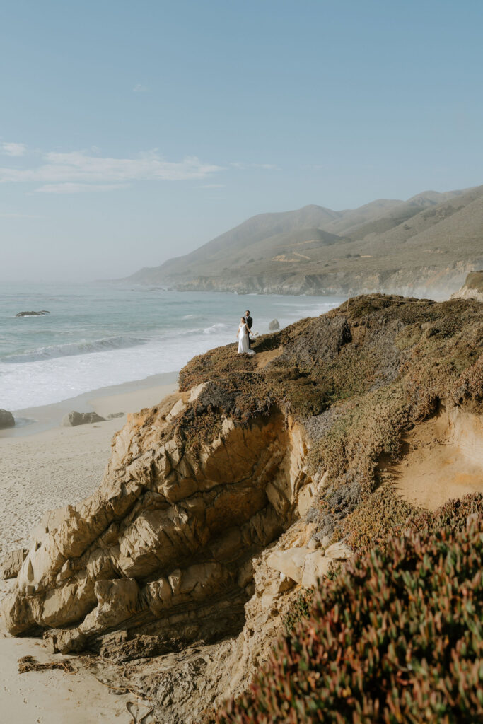 bride and groom in garrapata state park overlooking the ocean