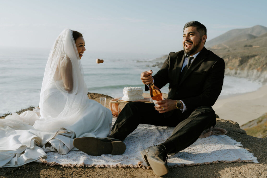 candid elopement picnic moments overlooking the ocean in garrapata