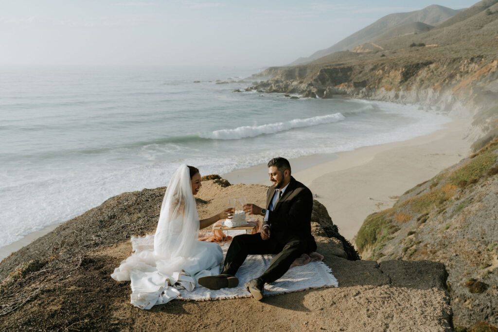 candid elopement picnic moments overlooking the ocean in garrapata