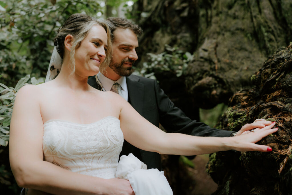 bride and groom surrounded by lush forest during their prairie creek redwoods elopement