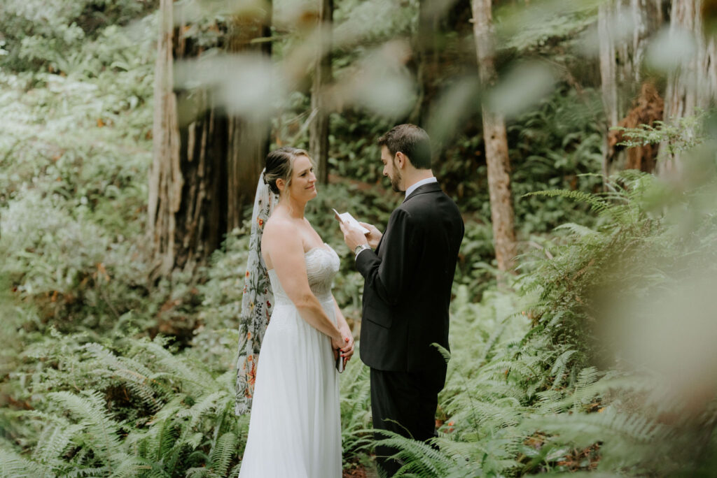 bride and groom exchanging private vows surrounded by lush forest during their prairie creek redwoods elopement