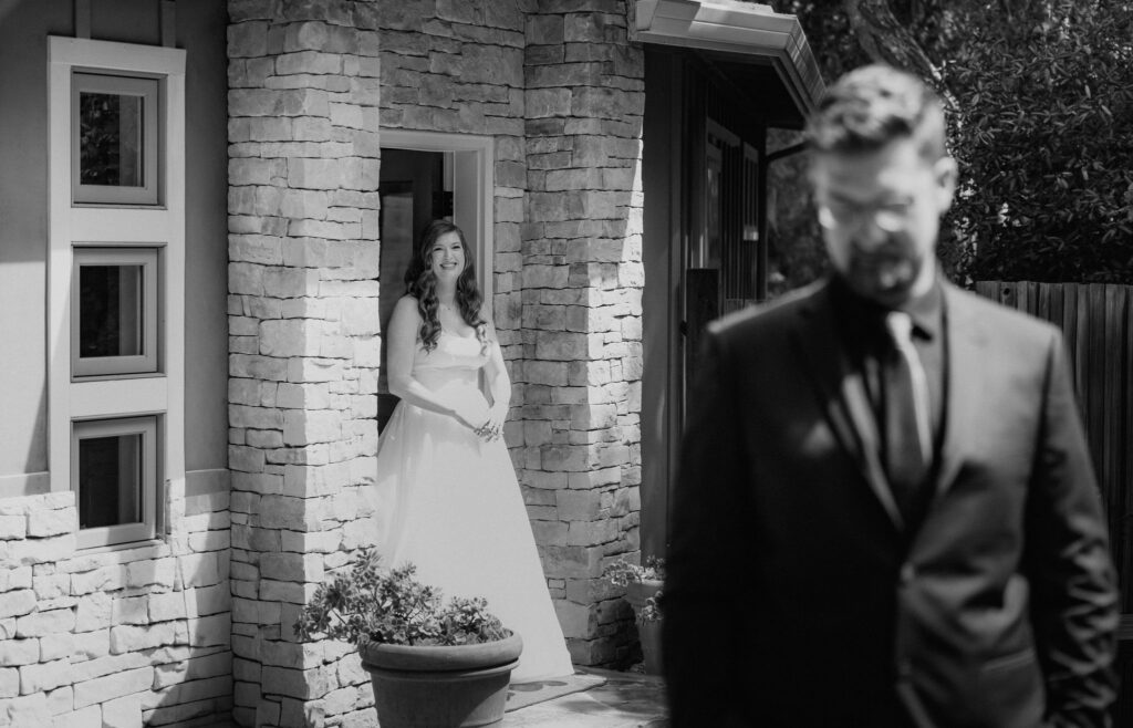bride and groom first look in front of their airbnb