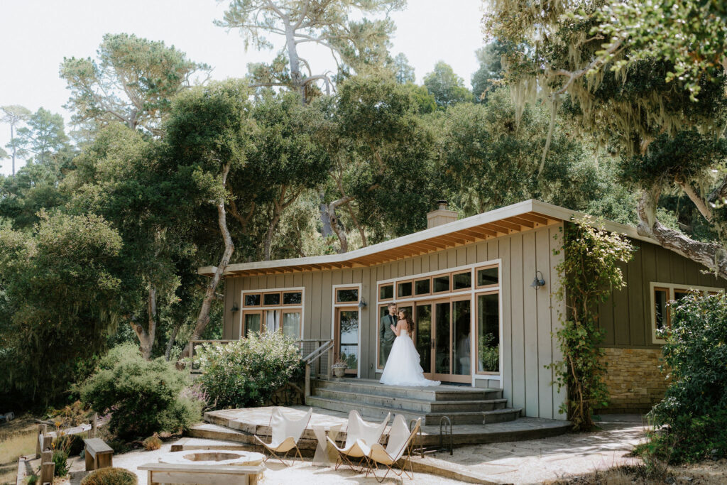 bride and groom first look in front of their airbnb