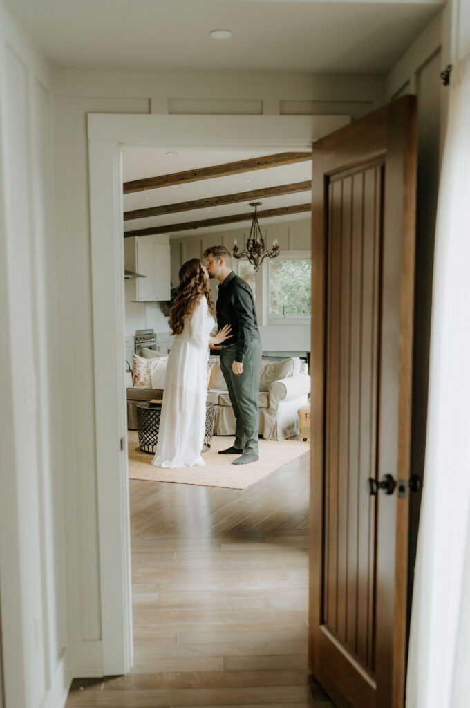 bride and groom kiss at the airbnb