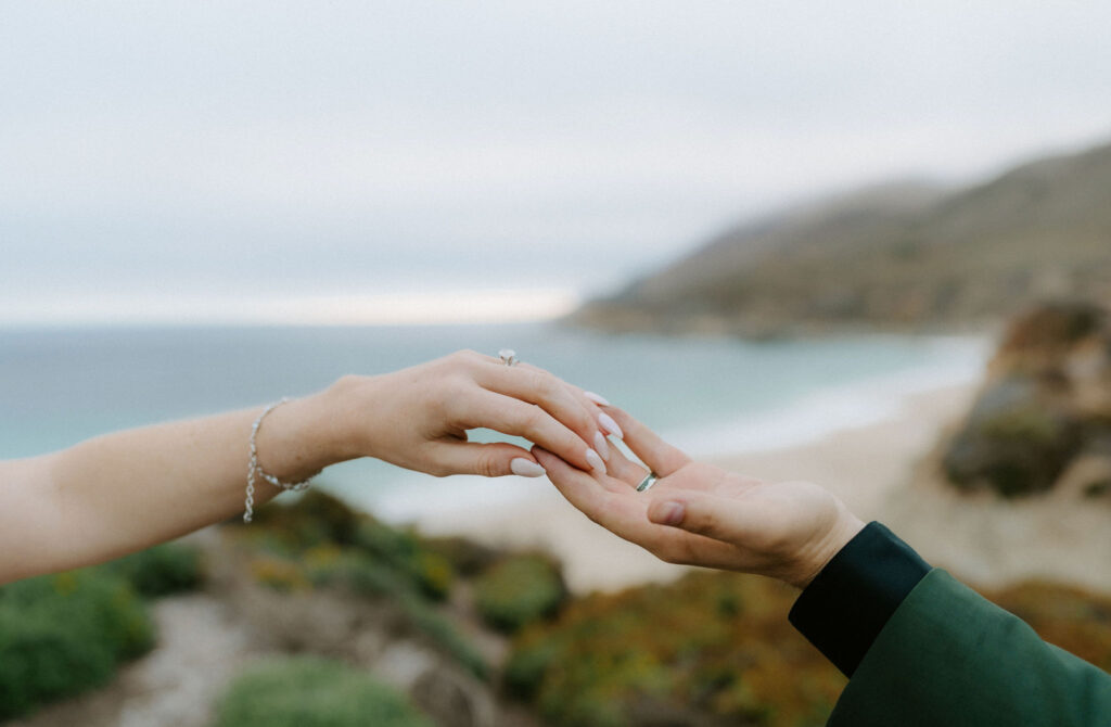 close up of bride and groom holding hands