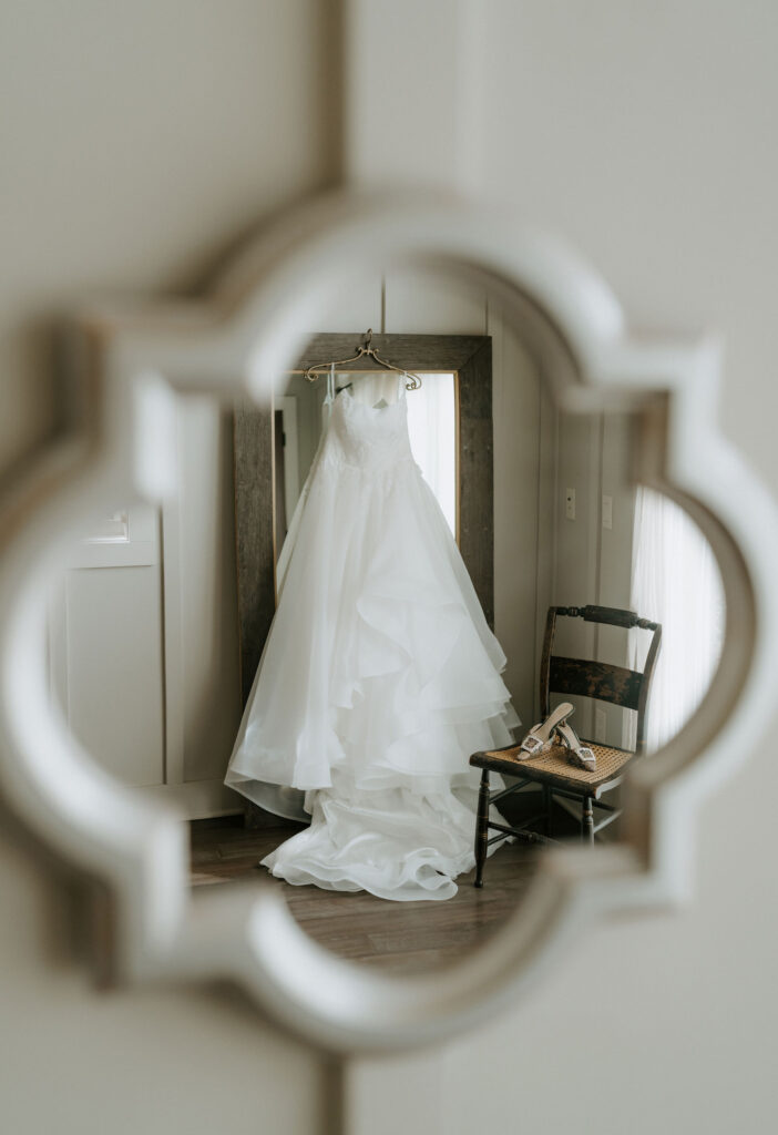 wedding dress hanging on a mirror