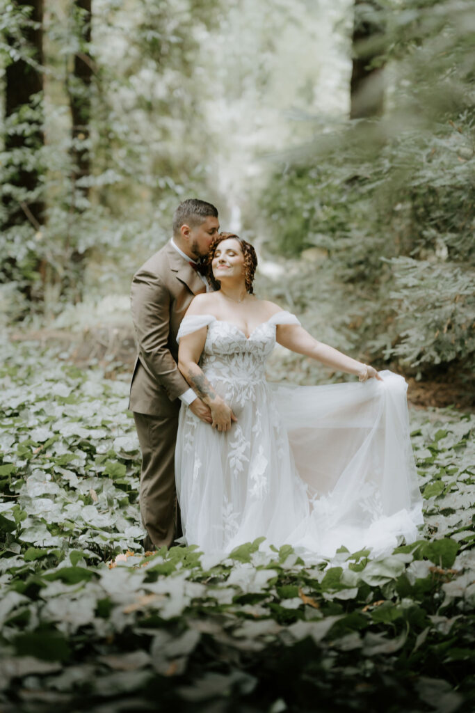 bride and groom surrounded by lush redwoods during their big sur fall elopement