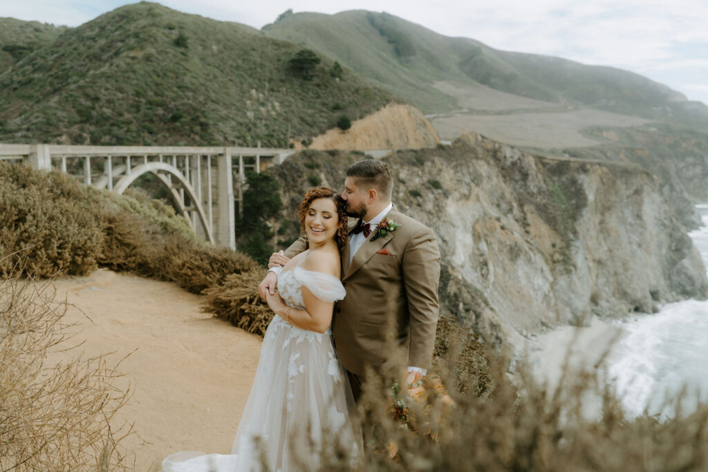 bride and groom inf front of bixby bridge