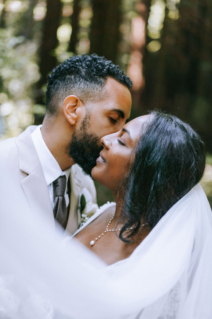 cute picture of the groom kissing the bride on the cheek