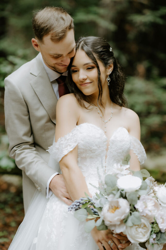 cute picture of the groom kissing the bride on the cheek