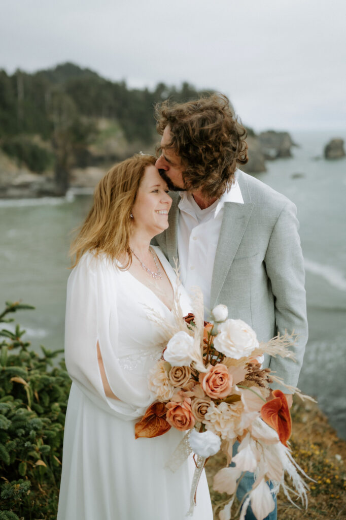 groom kissing the bride on the forehead