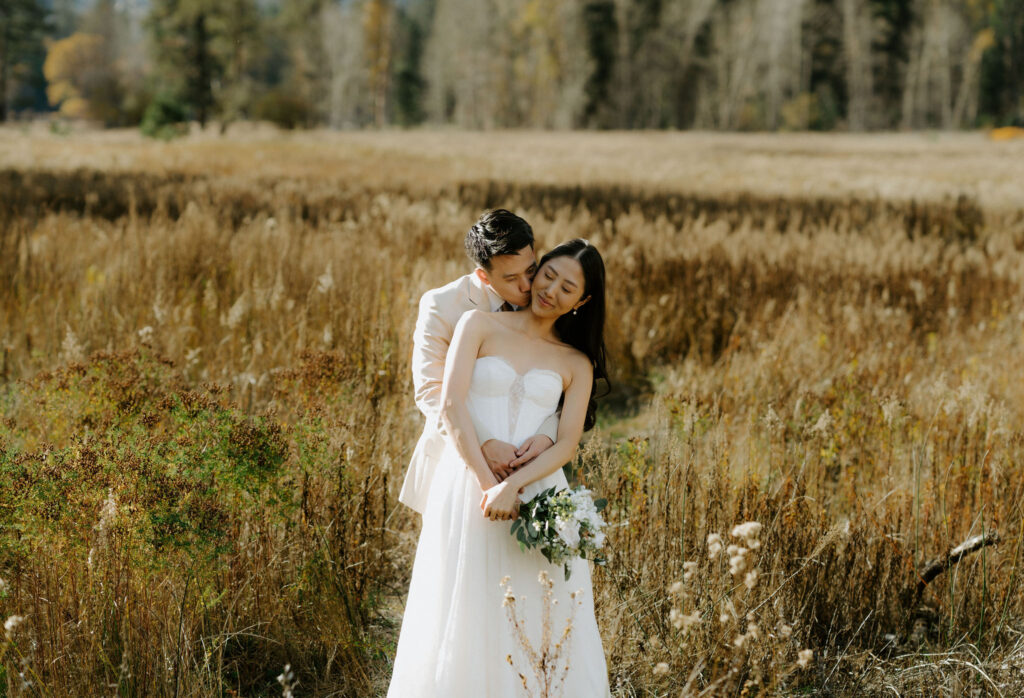 groom kissing the bride on the cheek