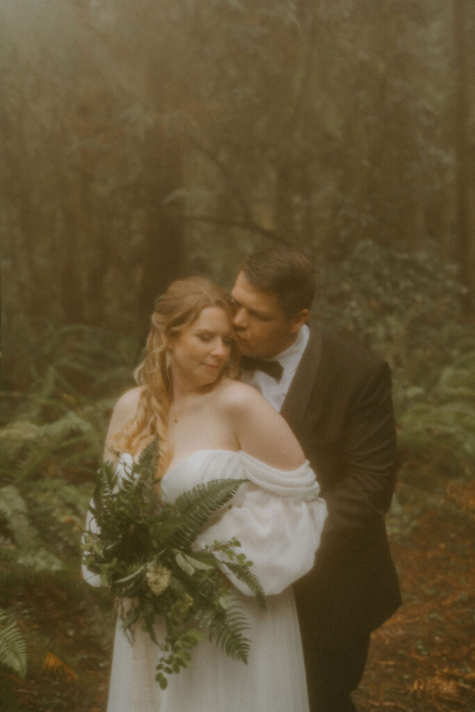 groom kissing the bride on the cheek