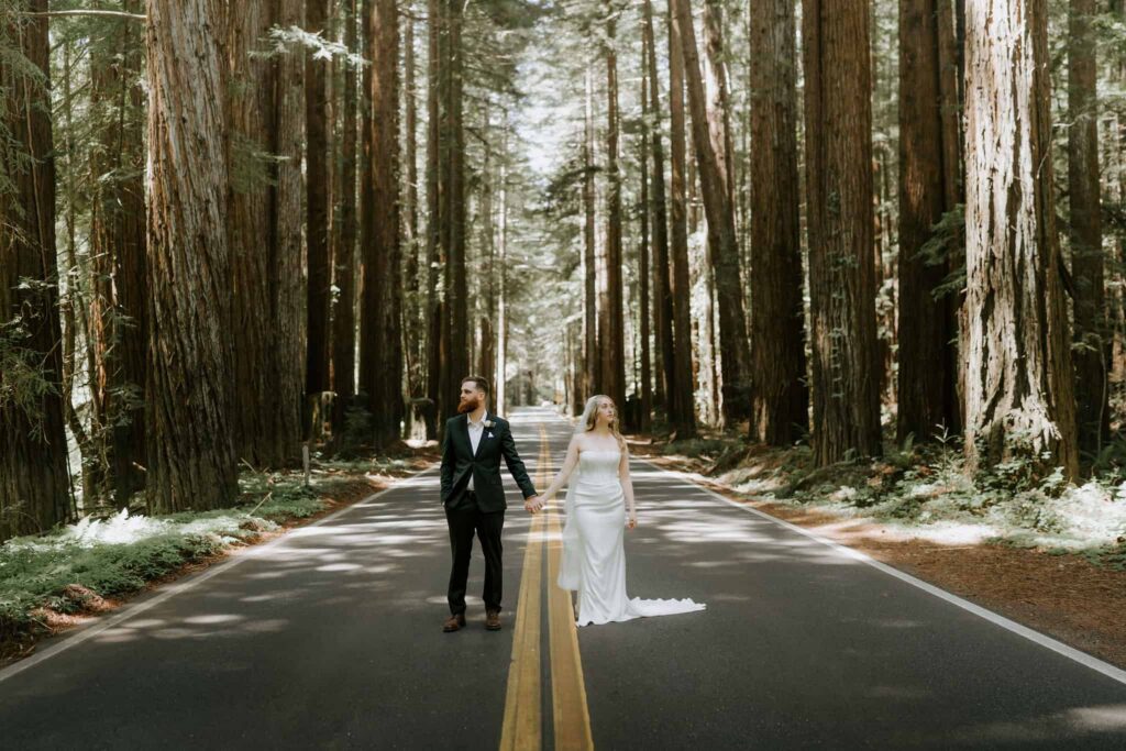 Redwood elopement couple standing among the trees in the road