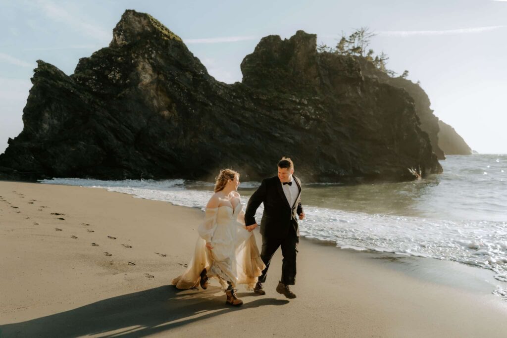 couple running on the mendocino beach for their elopement