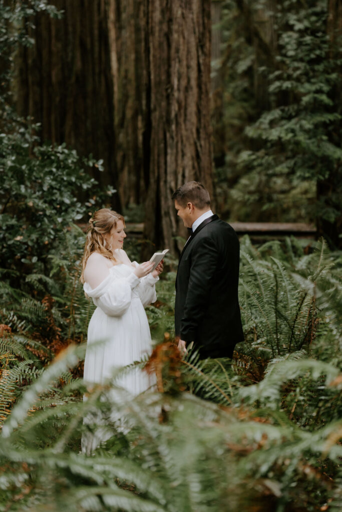 bride and groom reading their vows