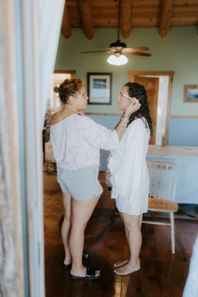 bride getting her makeup done before the ceremony