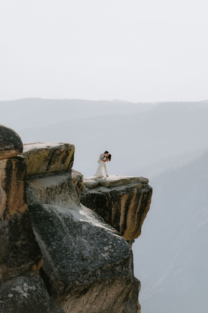 beautiful picture of the newlyweds kissing at taft point