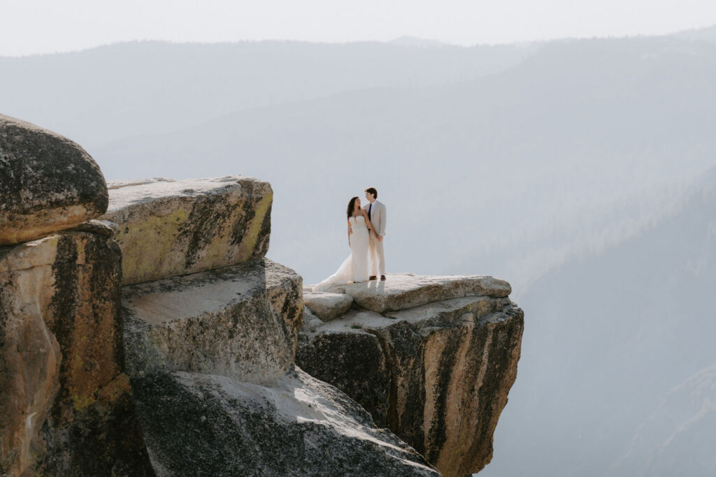 newlyweds at taft point for sunset in yosemite