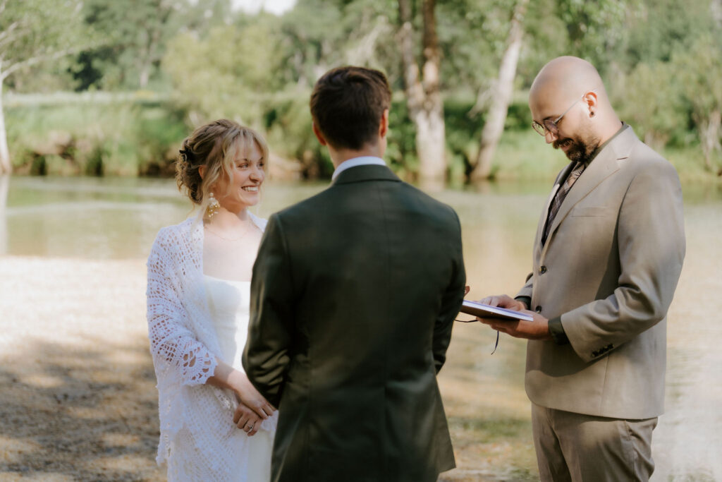 bride and groom holding hands during theor ceremony