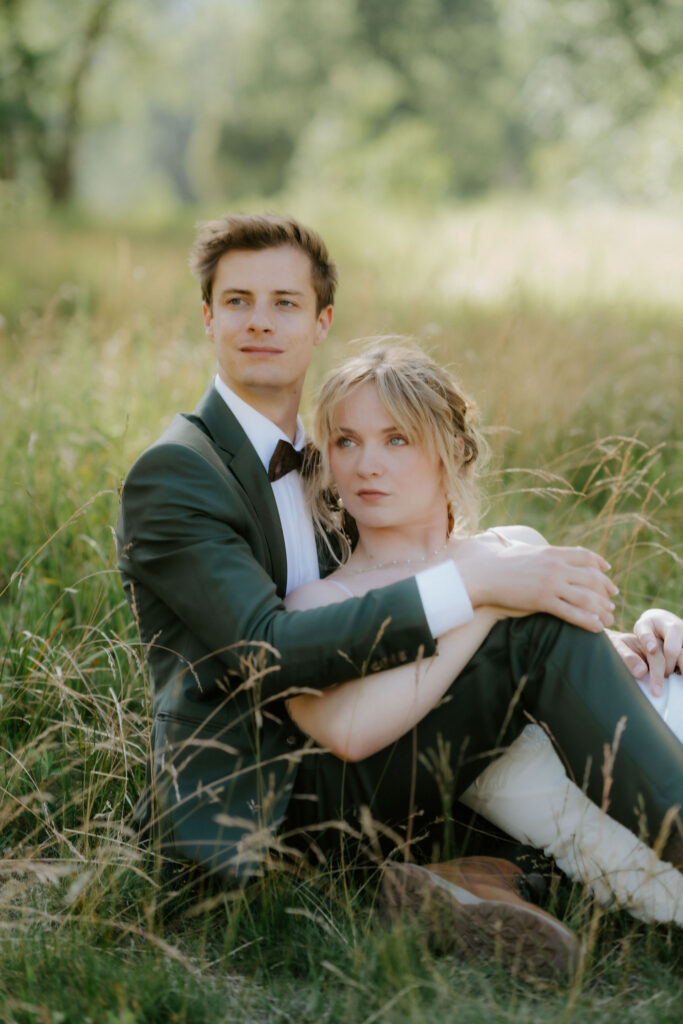 newlyweds smiling at the camera during their photoshoot