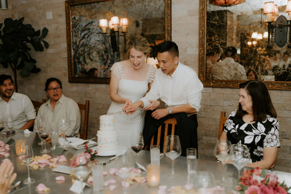 cute picture of the newlyweds cutting their wedding cake