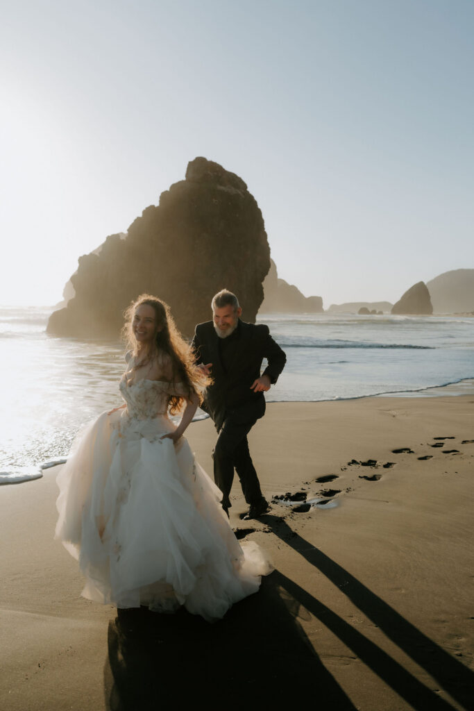 Couple running around the beach during their photo shoot