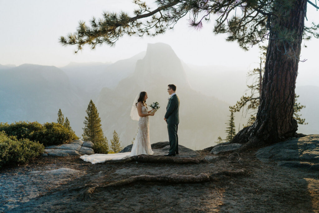 bride and groom reading their vows during sunrise