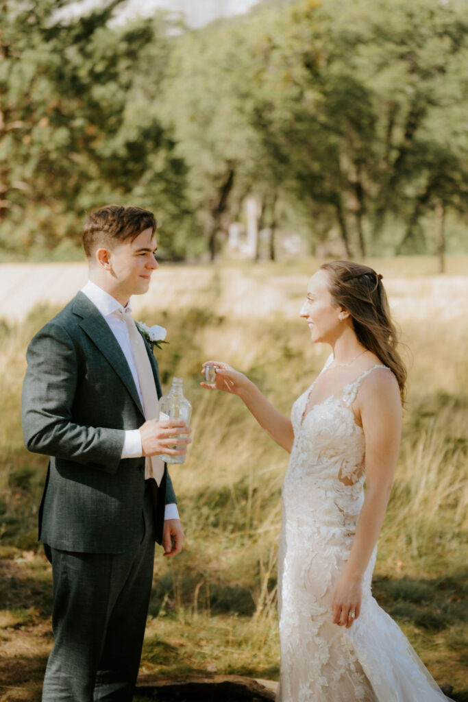 newlyweds celebrating their elopement with a drink