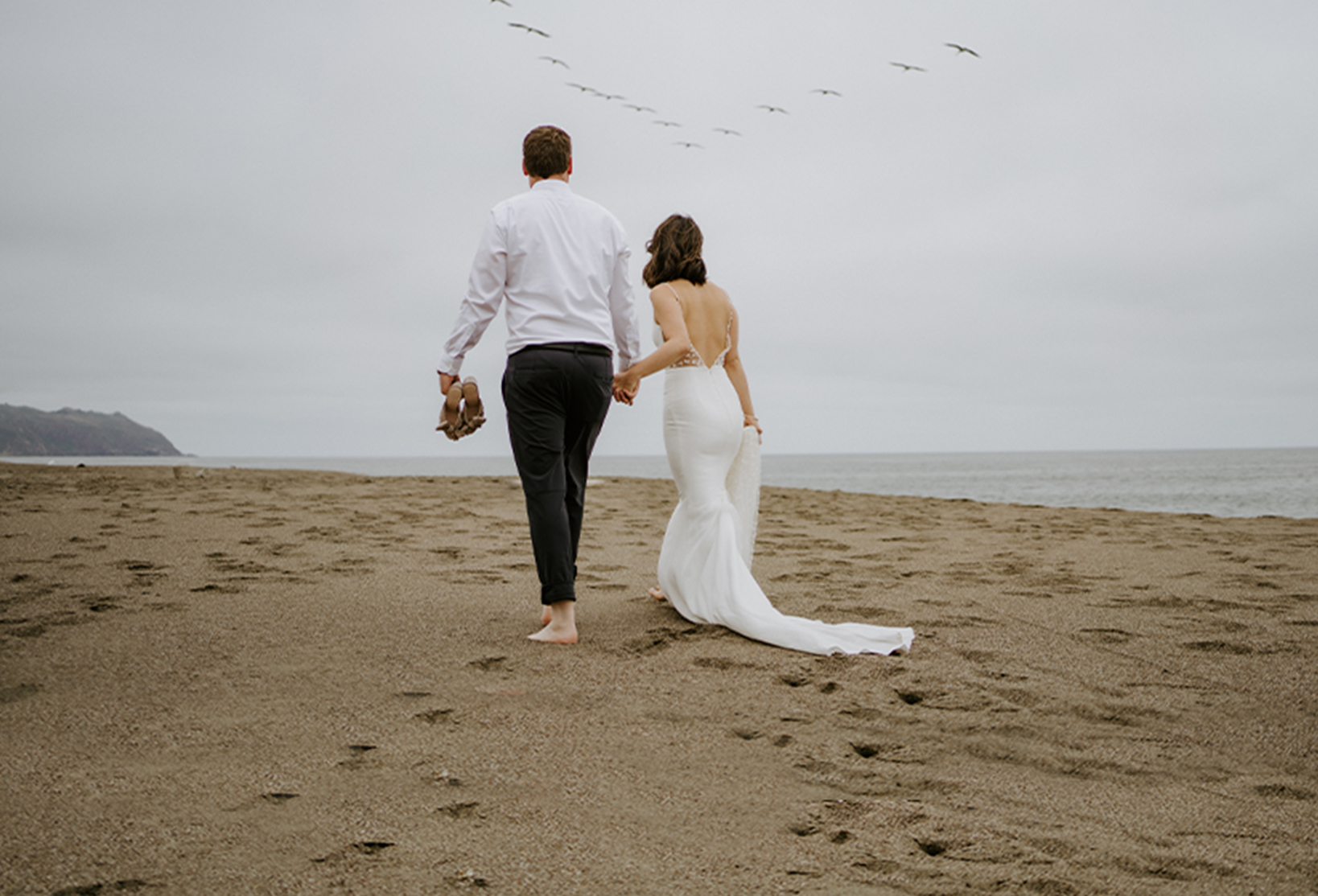 Couple walking on beach Northern California Coastal Elopement