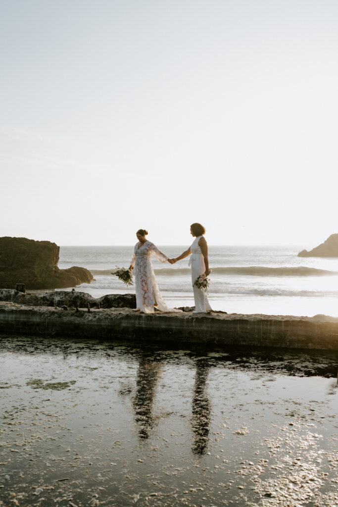 couple walking in sunset at sutro baths