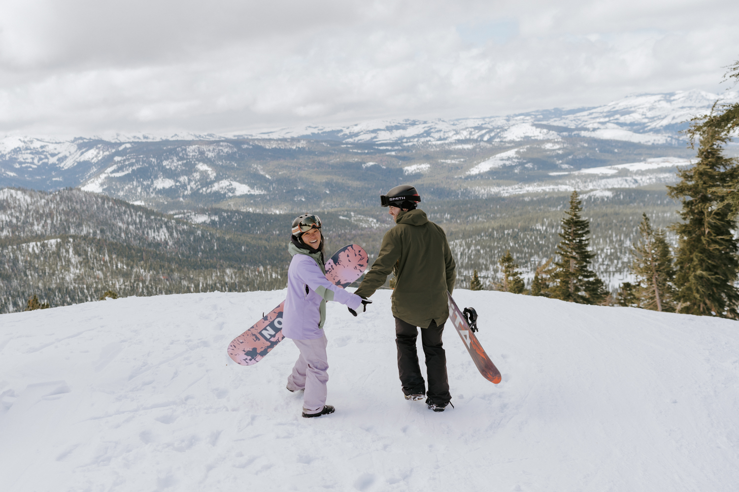 couple with snowboards on adventure proposal in the snow