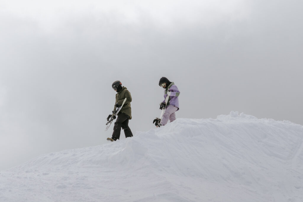 snowboard adventure couple in the snow during Lake Tahoe proposal