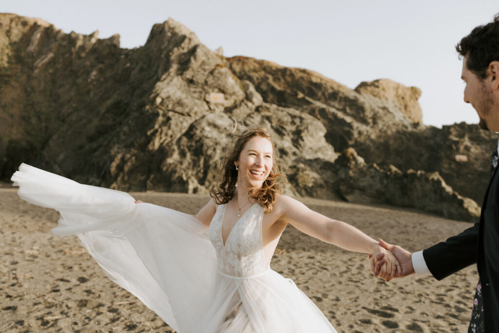 couple exploring the beach on their elopement