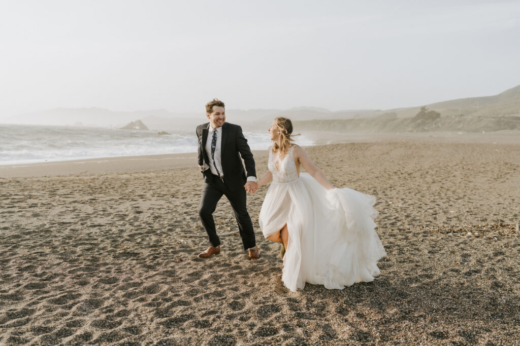 couple running the beach eloping in mendocino california
