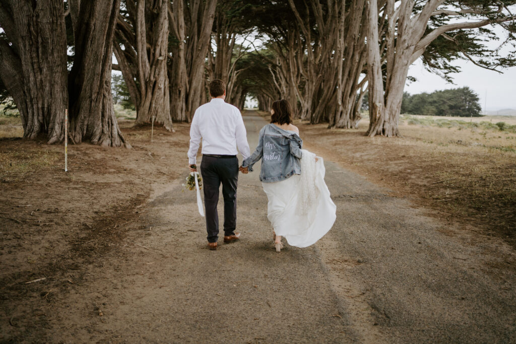eloping couple walking cypress tunnel in point reyes