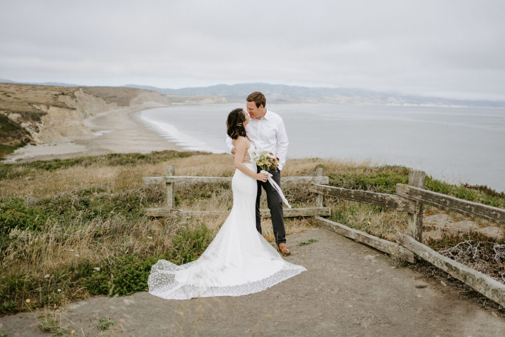 Point Reyes eloping couple overlooking beach