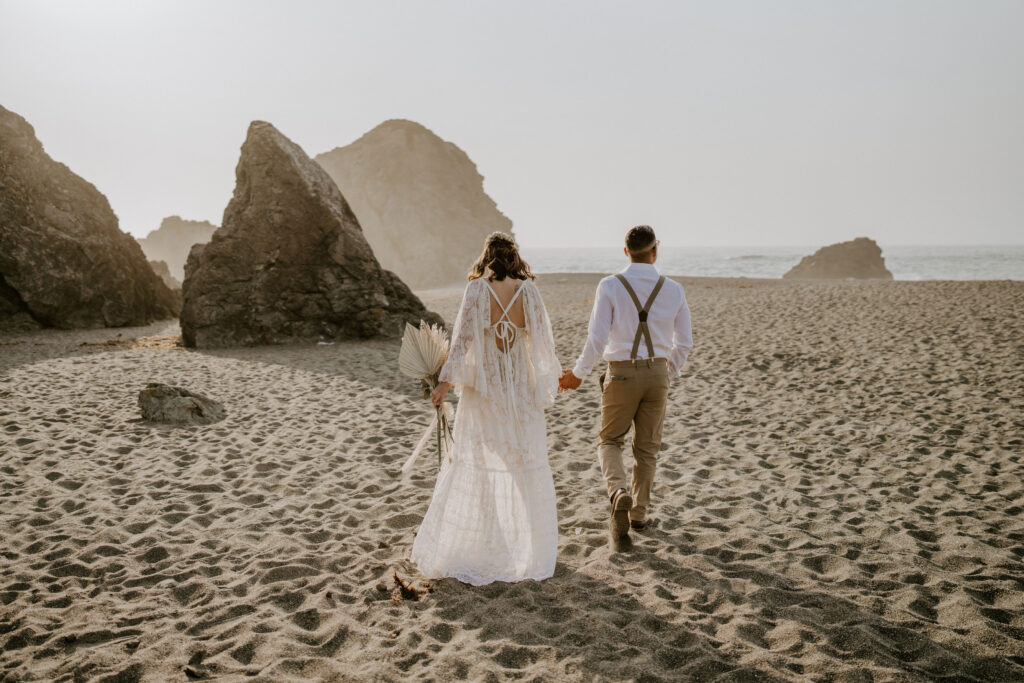 elopement couple in bodega bay walking the beach
