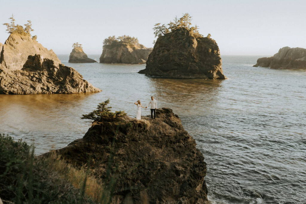 adventurous elopement couple standing on a rugged cliff in redwood national park